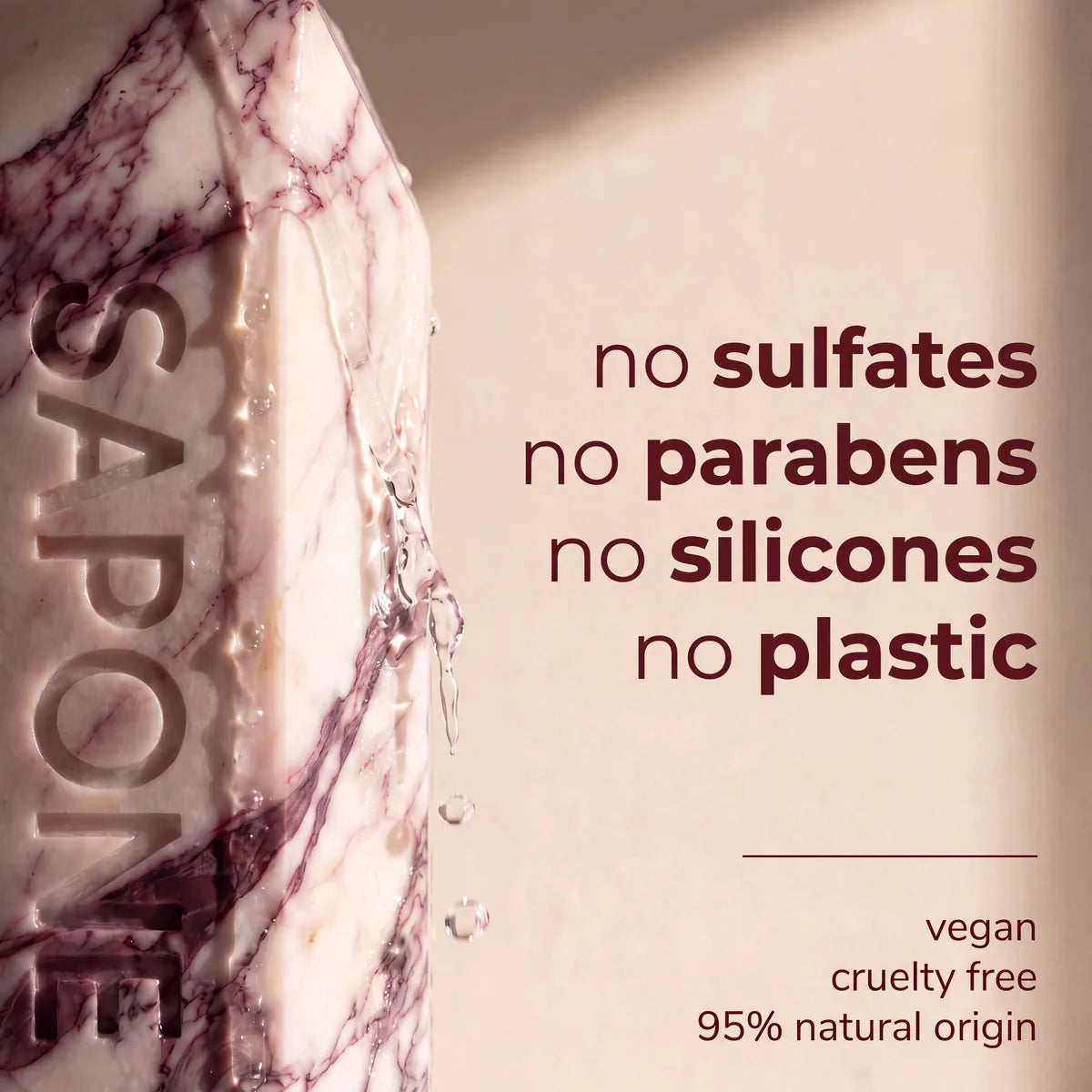 A close-up of a wet Sapone bottle. The formula has no sulfates, parabens, silicones or plastic, and is vegan, cruelty free and 95% natural in origin.